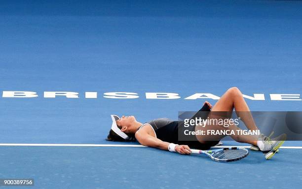 Garbine Muguruza of Spain reacts before retiring from her second round match against Aleksandra Krunic of Serbia at the Brisbane International tennis...