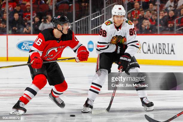 Patrick Kane of the Chicago Blackhawks in action against Steven Santini of the New Jersey Devils on December 23, 2017 at Prudential Center in Newark,...