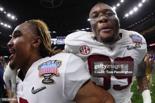 Jalen Hurts of the Alabama Crimson Tide and Raekwon Davis celebrate after the AllState Sugar Bowl against the Clemson Tigers at the Mercedes-Benz...
