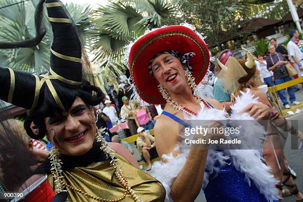 People dress in costumes as they participate October 27, 2001 in the Key West, Florida Fantasy Fest. The costume and mask event lasts 10 days.