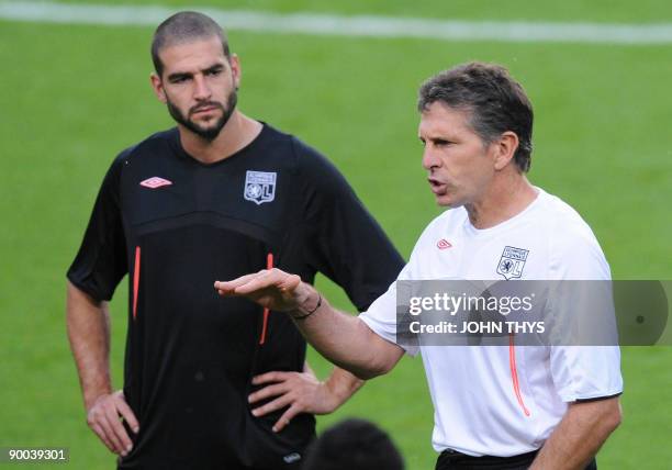 Olympique Lyonnais player Lisandro Lopez and his coach Claude Puel are pictured during a training session at the Constant Vanden Stock Stadium in...