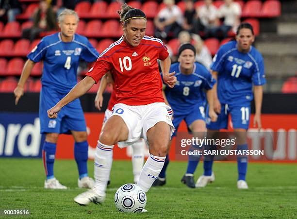 France's Camille Abily shoots and scores a goal from a penalty kick during a UEFA women's Euro 2009 football match Iceland vs France in Tampere, on...