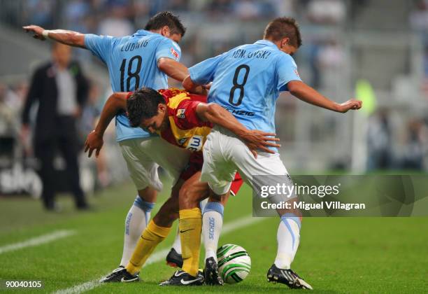 Andreas Schaefer of Karlsruher SC and Alexander Ludwig and Aleksandar Ignjovski of TSV 1860 Muenchen challenge for the ball during the 2. Bundesliga...