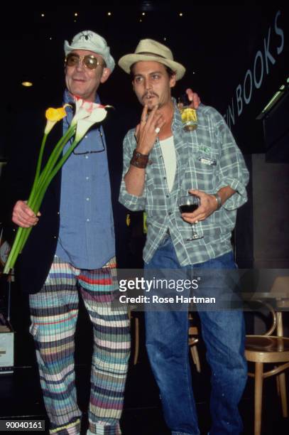 American author and journalist Hunter S. Thompson and aactor Johnny Depp pose together on a podium in the atrium of the Times Square Virgin...
