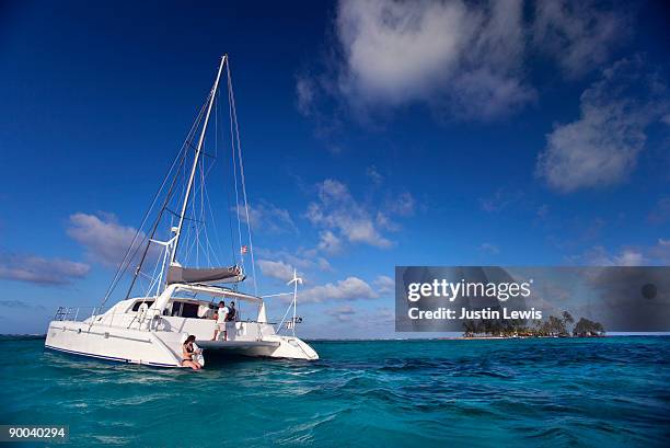 catamaran in caribbean with small island  - catamaran stock pictures, royalty-free photos & images