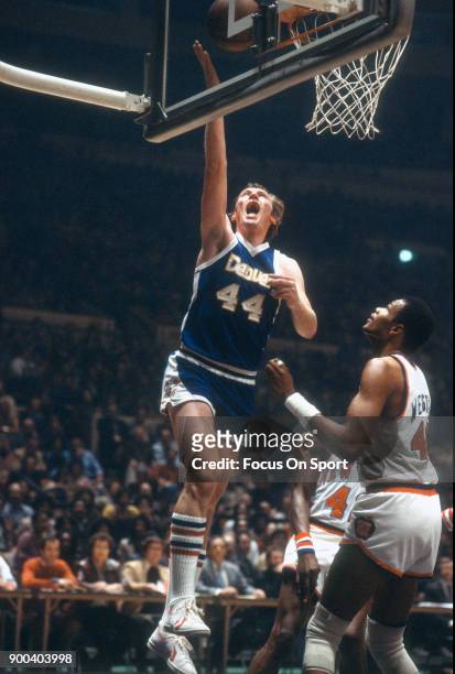Dan Issel of the Denver Nuggets shoots over Marvin Webster of the New York Knicks during an NBA basketball game circa 1978 at Madison Square Garden...