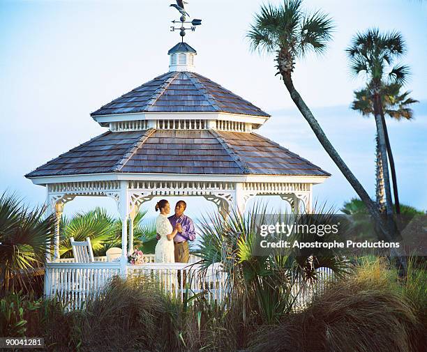 couple embracing under gazebo - apostrophe stock pictures, royalty-free photos & images