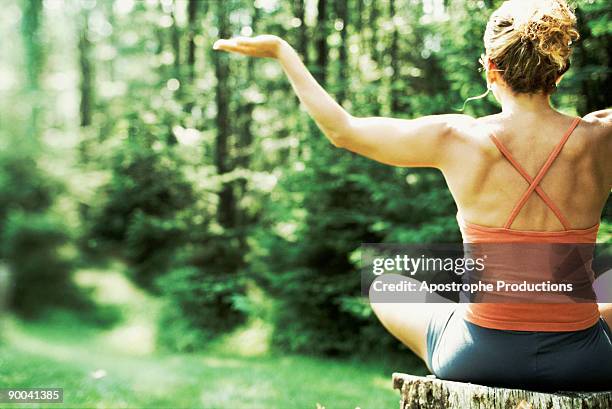 woman meditating in forest - apostrophe stock pictures, royalty-free photos & images