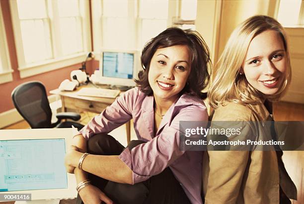 businesswomen sitting in office - apostrophe stock pictures, royalty-free photos & images