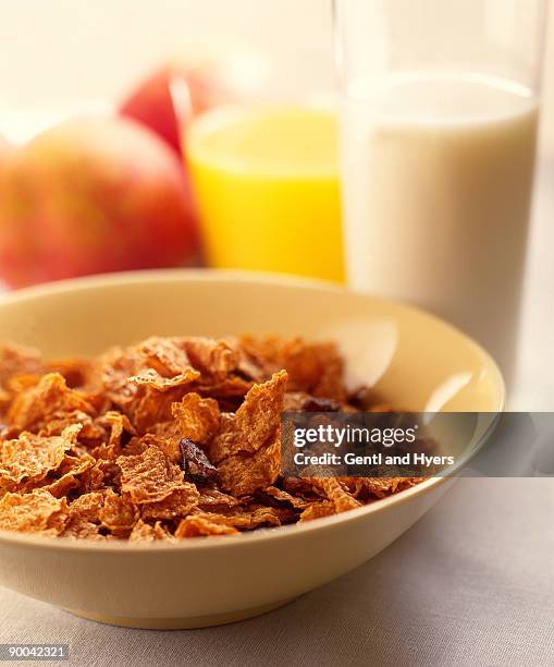 cold cereal with raisins in bowl - raisin bran stock pictures, royalty-free photos & images