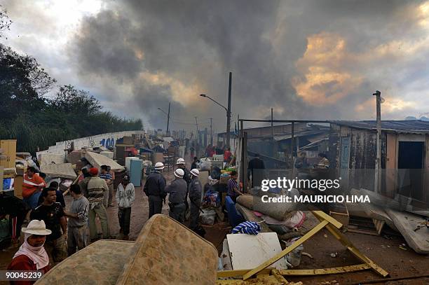 Residents take care of their belongings during an eviction at Capao Redondo shantytown, southern outskirts of Sao Paulo, Brazil, on August 24, 2009....