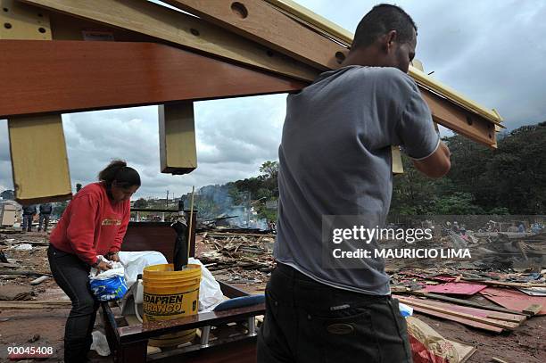 Residents attempt to save their belongings during an eviction at Capao Redondo shantytown, southern outskirts of Sao Paulo, Brazil, on August 24,...