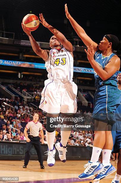 Le'coe Willingham of the Phoenix Mercury goes up for a shot against Tasha Humphrey of the Minnesota Lynx during the game at US Airways Center on July...
