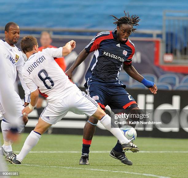 Shalrie Joseph of the New England Revolution drives the ball around Will Johnson of Real Salt Lake during the MLS match August 23, 2009 at Gillette...