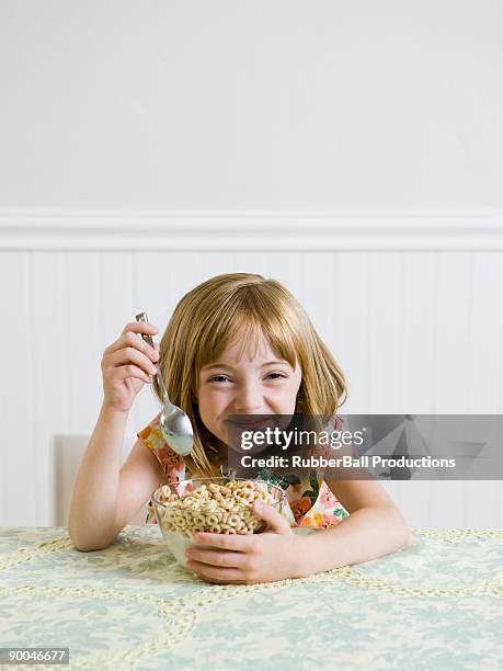 girl at the kithen table - eating cereal stock pictures, royalty-free photos & images