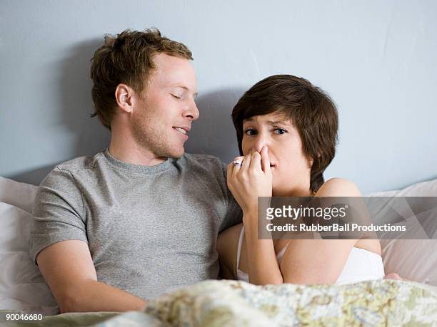 couple in bed - 鼻をつまむ ストックフォトと画像