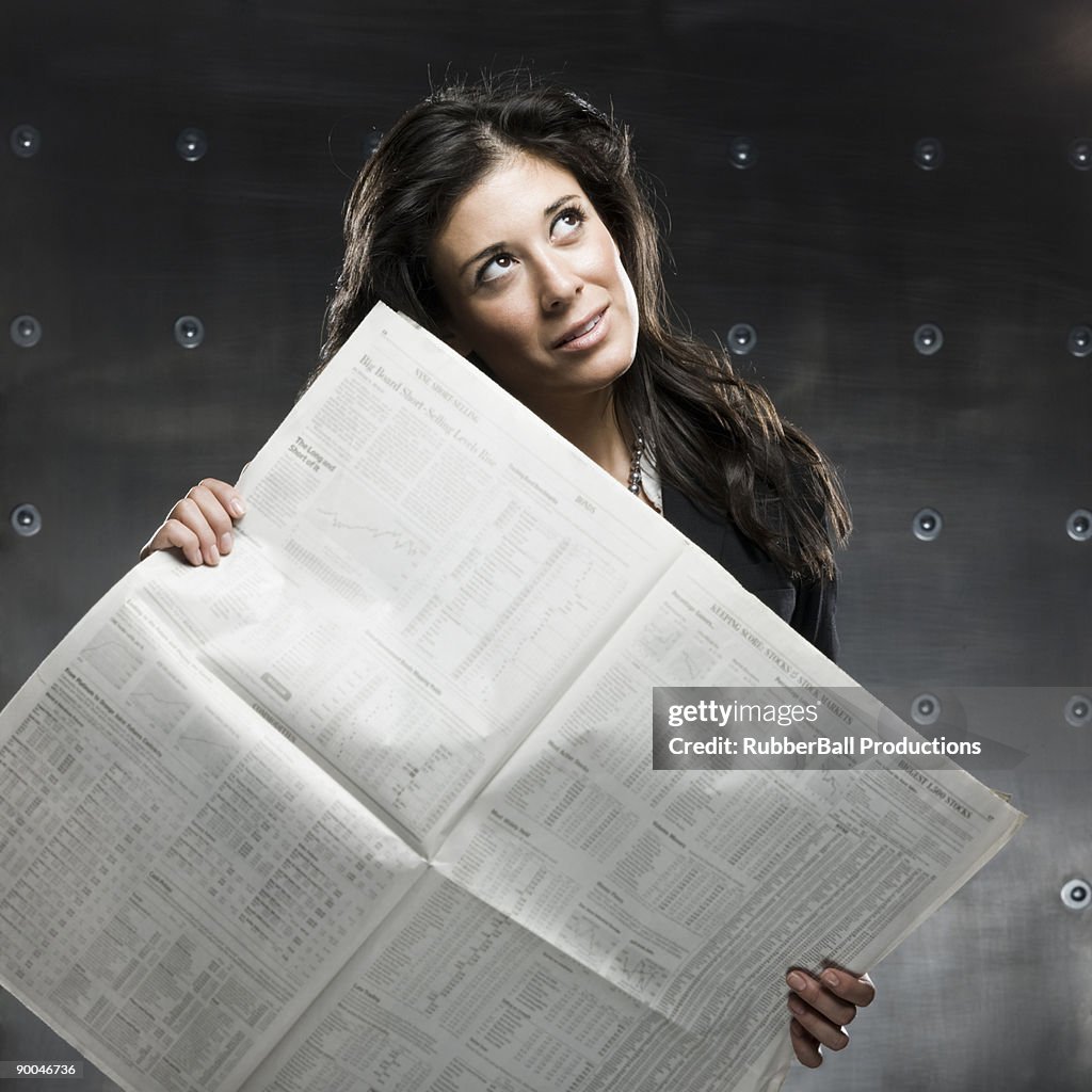 Businesswoman holding a newspaper