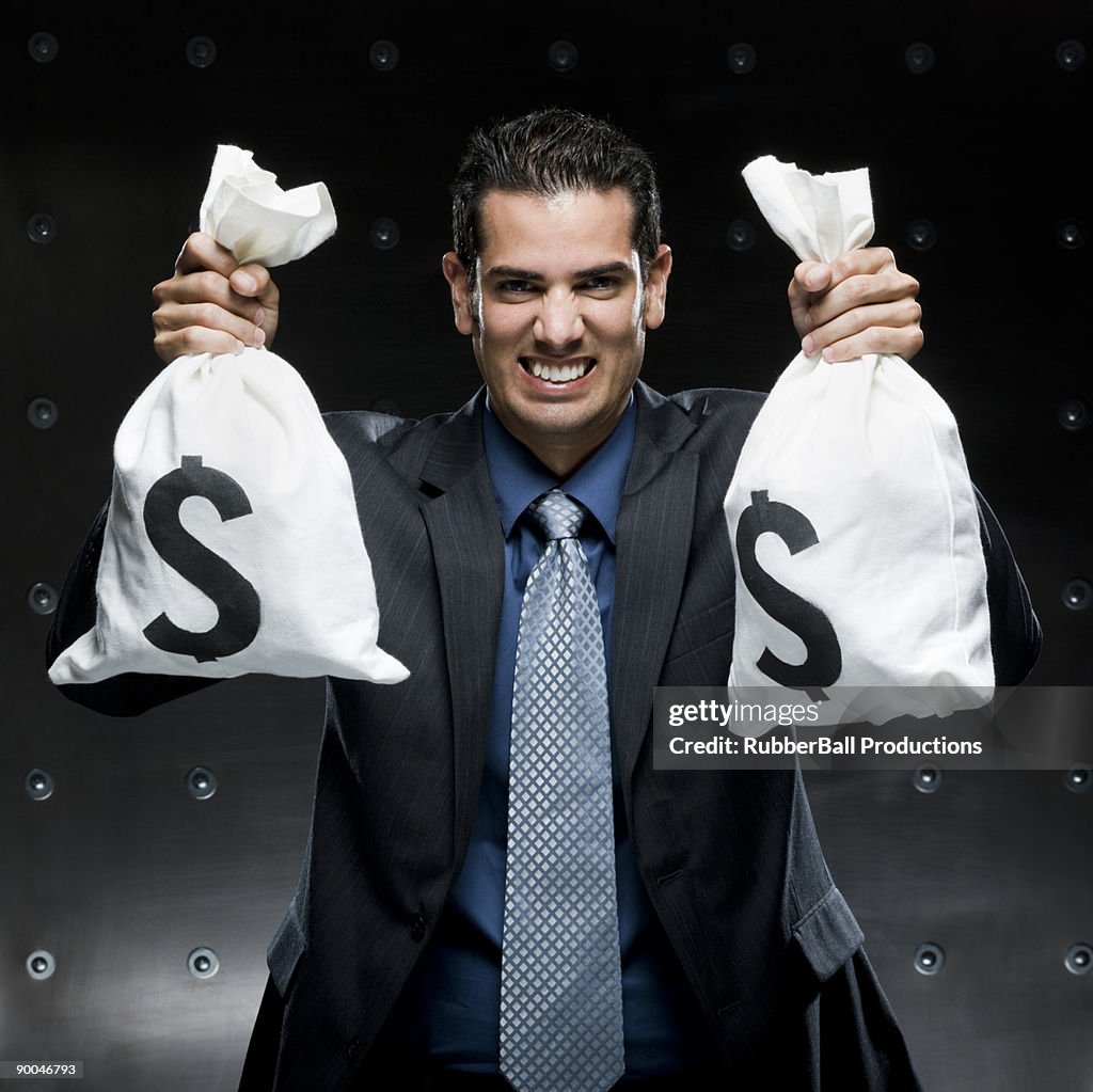 Businessman holding a bag of money