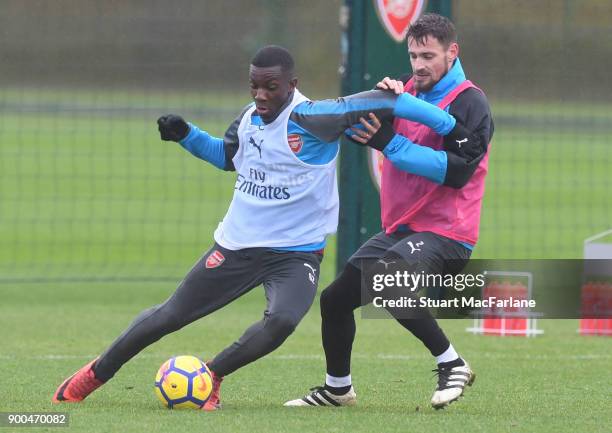 Eddie Nketiah and Mathieu Debuchy of Arsenal during a training session at London Colney on January 2, 2018 in St Albans, England.