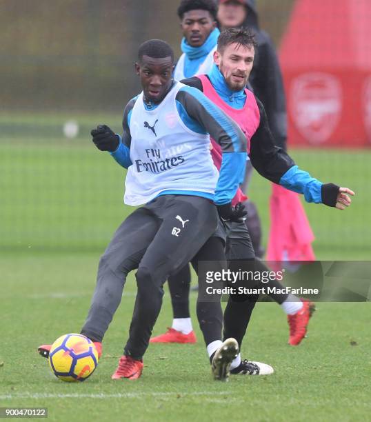Eddie Nketiah and Mathieu Debuchy of Arsenal during a training session at London Colney on January 2, 2018 in St Albans, England.