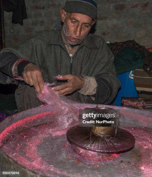 Ghulam Muhammad Bhat makes cotton candy or candy floss on his his typical machine, inside his home, on January 2 in Srinagar, the summer capital of...