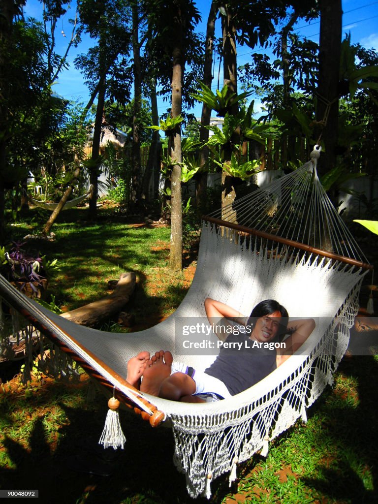 A young man relaxing in a hammock