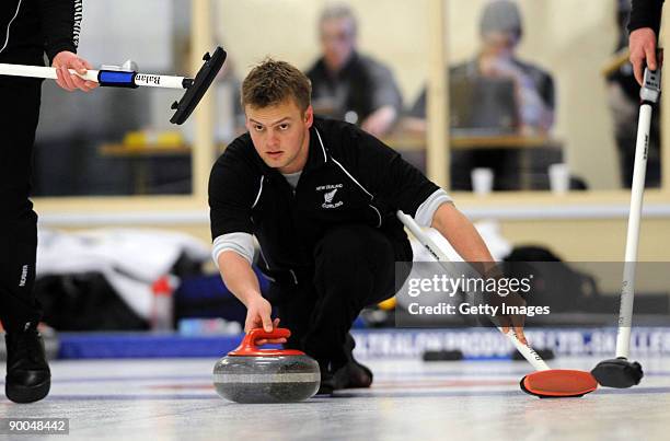 Scott Becker of New Zealand competes in the Men's Curling during day four of the Winter Games NZ at Maniototo Ice Rink on August 25, 2009 in Naseby,...