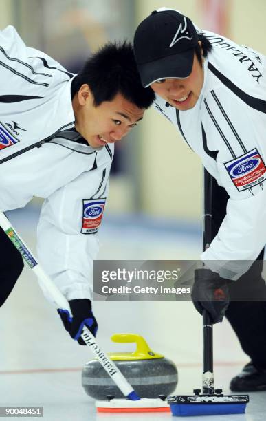 Tetsuro Shimizu and Tsuyoshi Yamaguchi of Japan compete in the Men's Curling during day four of the Winter Games NZ at Maniototo Ice Rink on August...
