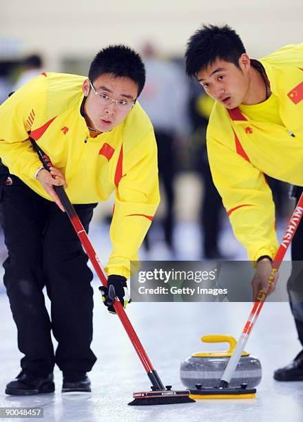 Zang Jialiang and Xu Xiaoming of China compete in the Men's Curling during day four of the Winter Games NZ at Maniototo Ice Rink on August 25, 2009...