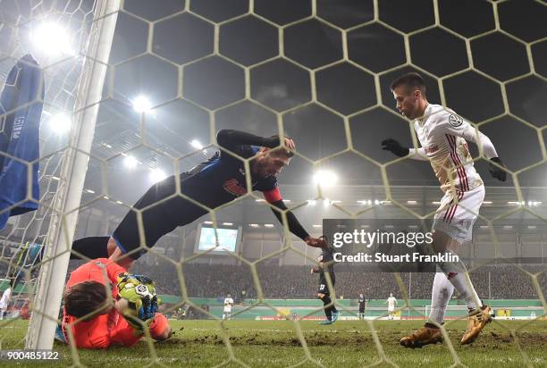 Michael Ratajczak of Paderborn makes a save from Stefan Lex of Ingolstadt during the DFB Cup match between SC Paderborn and FC Ingolstadt at Benteler...