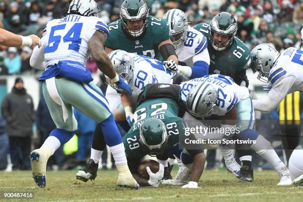 Philadelphia Eagles running back LeGarrette Blount is tackled by.Dallas Cowboys defensive end Taco Charlton and Dallas Cowboys middle linebacker Sean...