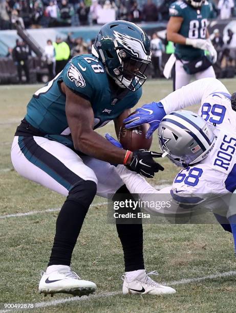 Wendell Smallwood of the Philadelphia Eagles forces a fumble from defensive end Daniel Ross of the Dallas Cowboys in the final second of the game at...