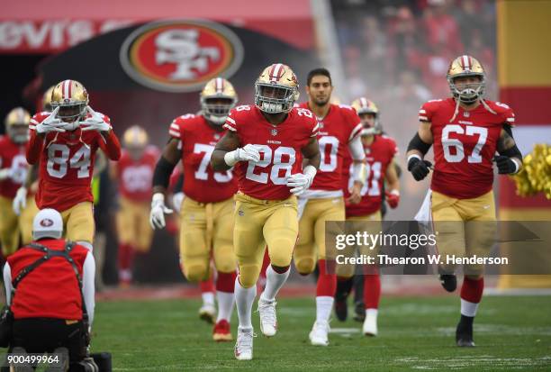 Carlos Hyde of the San Francisco 49ers leads the team running onto the field prior to the start of an NFL football game against the Jacksonville...