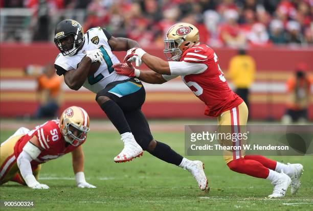 Leonard Fournette of the Jacksonville Jaguars gets tackled by Brock Coyle of the San Francisco 49ers during their NFL football game at Levi's Stadium...