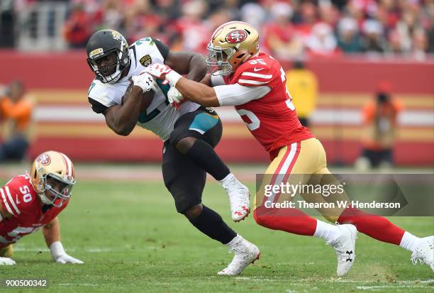 Leonard Fournette of the Jacksonville Jaguars gets tackled by Brock Coyle of the San Francisco 49ers during their NFL football game at Levi's Stadium...