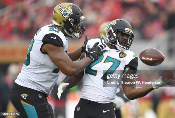 Leonard Fournette of the Jacksonville Jaguars is congratulated by Calais Campbell after Fournette scored a touchdown against the San Francisco 49ers...