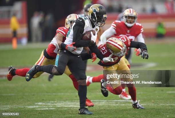 Yeldon of the Jacksonville Jaguars gets tackled by K'Waun Williams and Ahkello Witherspoon of the San Francisco 49ers during their NFL football game...