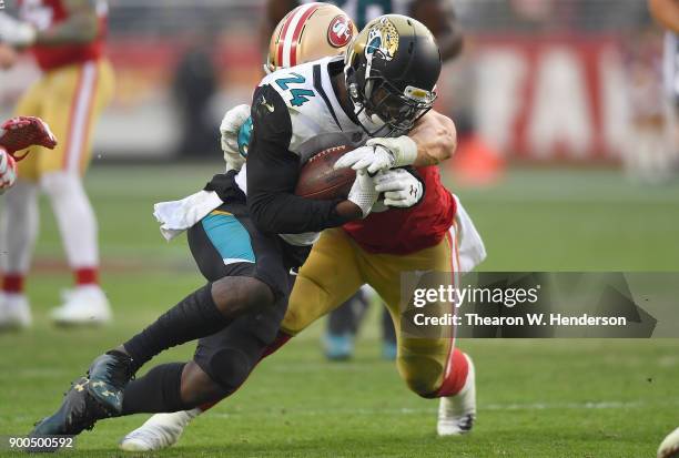 Yeldon of the Jacksonville Jaguars carries the ball while pursued by Brock Coyle of the San Francisco 49ers during their NFL football game at Levi's...