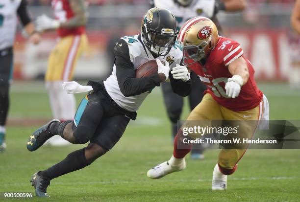 Yeldon of the Jacksonville Jaguars carries the ball while pursued by Brock Coyle of the San Francisco 49ers during their NFL football game at Levi's...