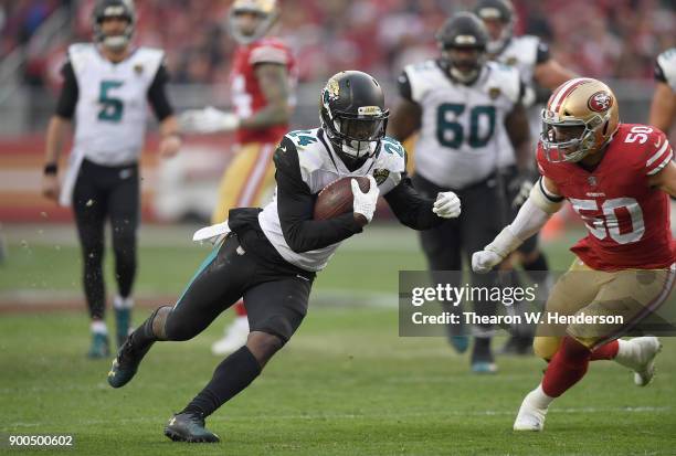 Yeldon of the Jacksonville Jaguars carries the ball while pursued by Brock Coyle of the San Francisco 49ers during their NFL football game at Levi's...