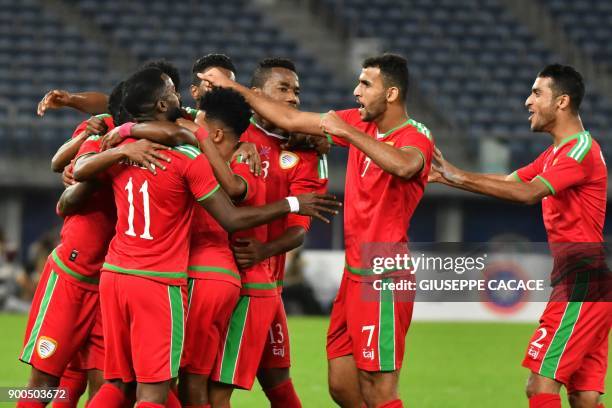 Oman's players celebrate after scoring a goal during the 2017 Gulf Cup of Nations semi-final football match between Oman and Bahrain at the Sheikh...