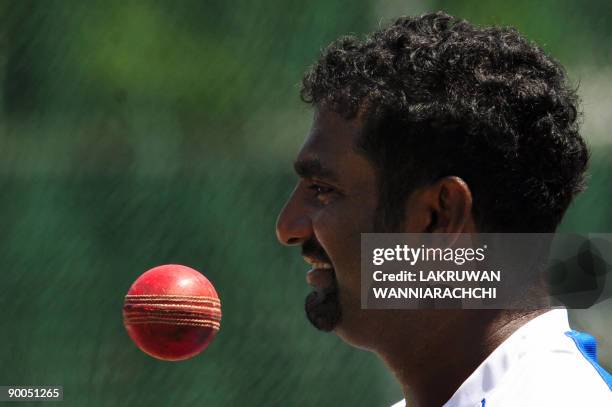 Sri Lankan cricketer Muttiah Muralitharan prepares to bowl during a practice session at The Sinhalese Sports Club grounds in Colombo on August 25,...