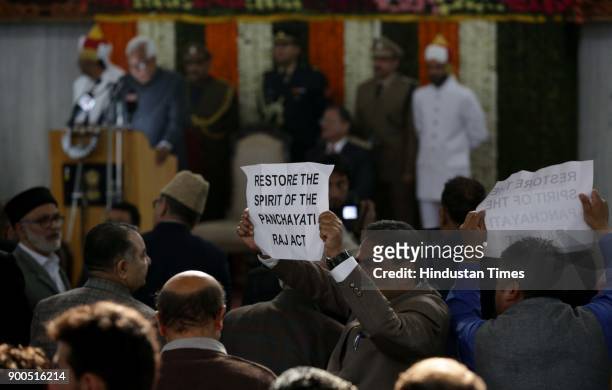 Jammu and Kashmir opposition parties, National Conference and Congress Members of the Legislative Assembly hold placards and shout slogans against...