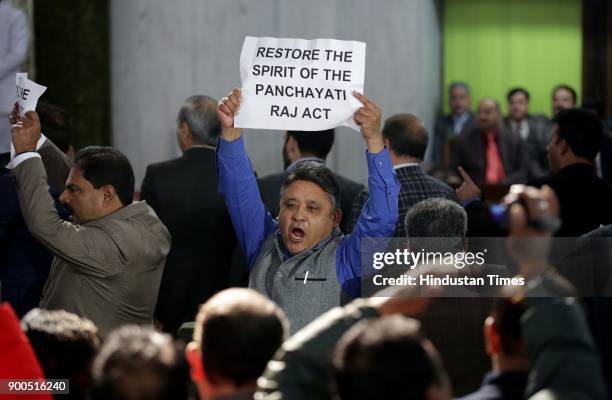 Jammu and Kashmir opposition parties, National Conference and Congress Members of the Legislative Assembly hold placards and shout slogans against...