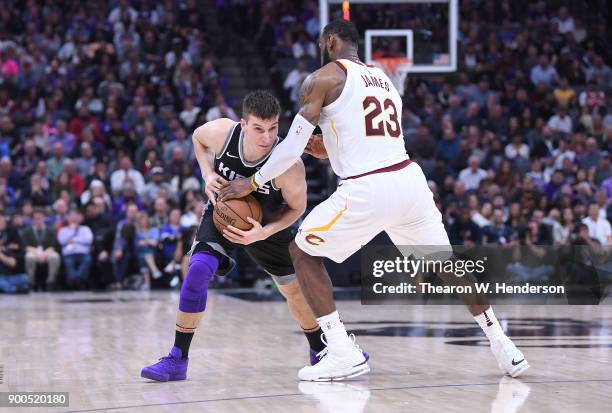 LeBron James of the Cleveland Cavaliers closely guards Bogdan Bogdanovic of the Sacramento Kings during their NBA basketball game at Golden 1 Center...