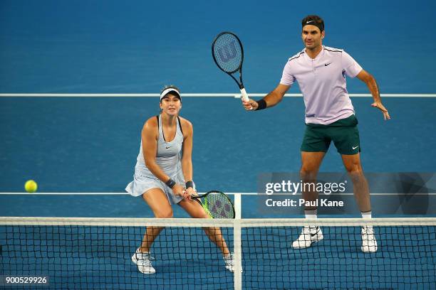 Belinda Bencic and Roger Federer of Switzerland play in the mixed doubles match against Anastasia Pavlyuchenkova and Karen Khachanov of Russia on Day...