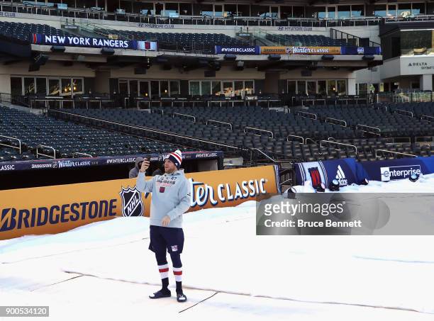 Steven Kampfer of the New York Rangers takes a selfie prior to the game against the Buffalo Sabres in the 2018 Bridgestone NHL Winter Classic at Citi...