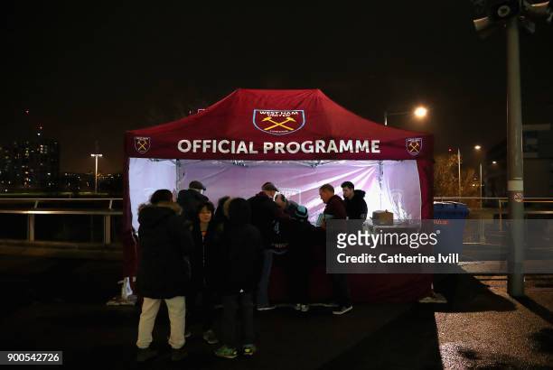 Fans buy the match programme prior to the Premier League match between West Ham United and West Bromwich Albion at London Stadium on January 2, 2018...