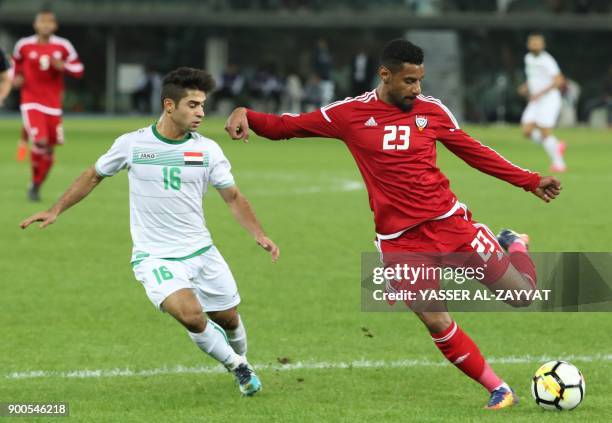 S Mohamed Ahmed kicks the ball as Iraq's Hussein Ali al-Saedi defends during the 2017 Gulf Cup of Nations semi-final football match between Iraq and...