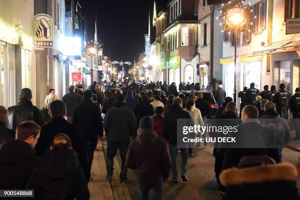 Friends, relatives and mourners take part in a march after a 15-year-old girl was stabbed to death by her Afghan ex-boyfriend, on January 2, 2018 in...